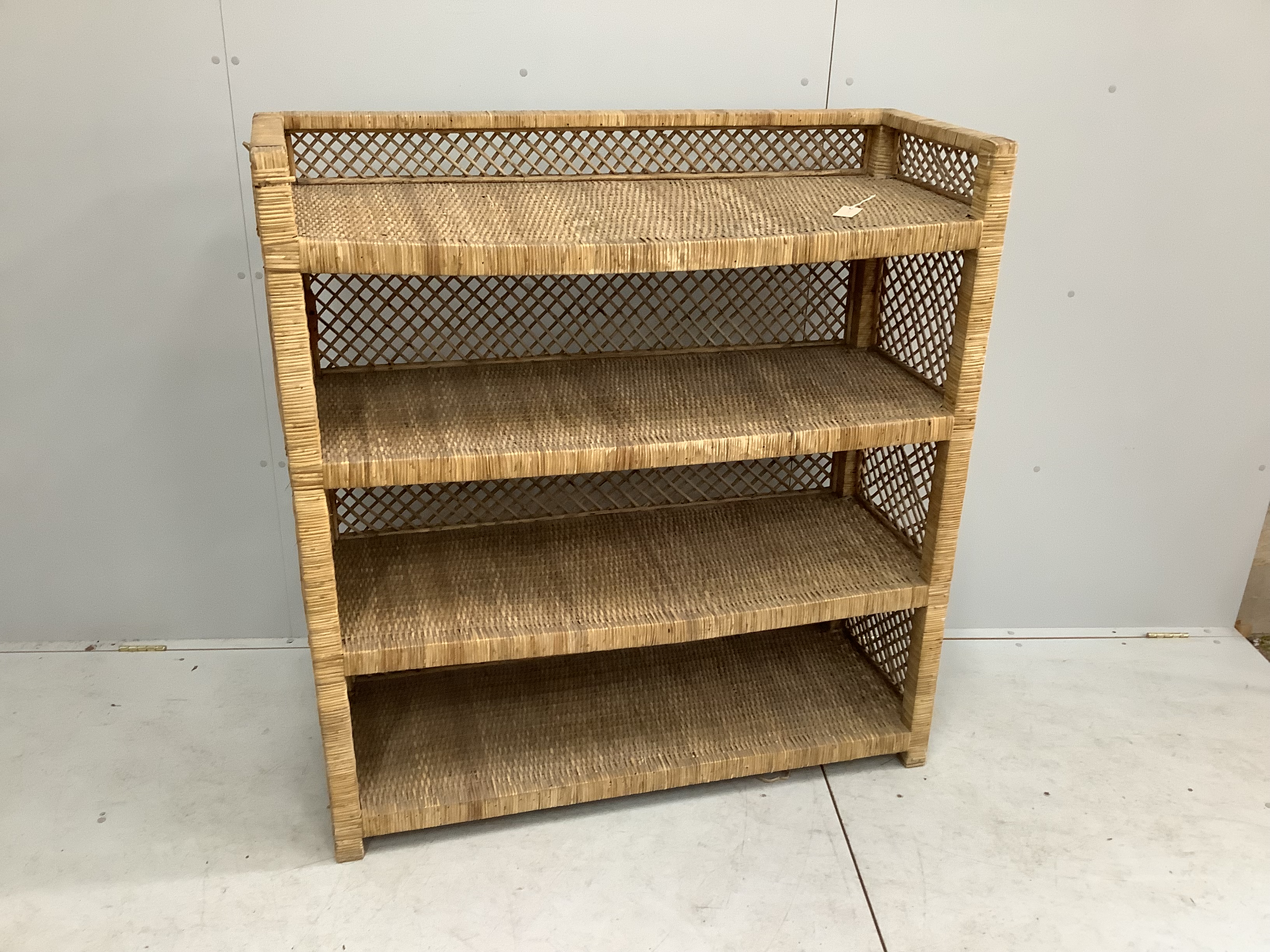 A wicker four tier shelving unit, width 121cm, depth 46cm, height 129cm